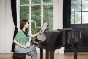 Woman composing music at a piano