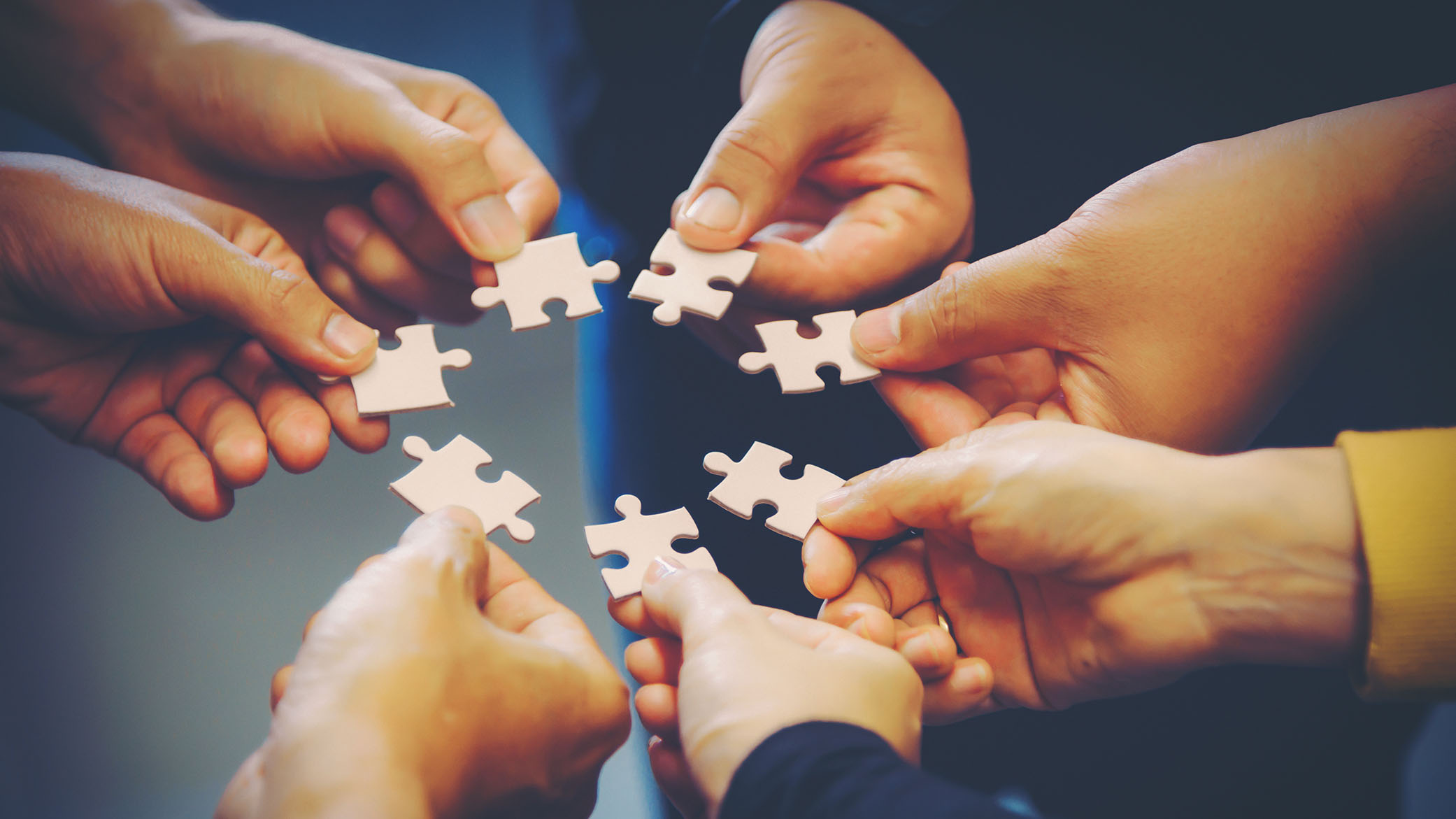 hands holding jigsaw pieces