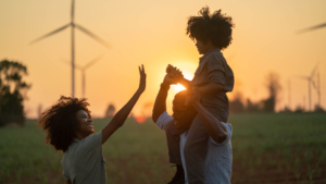 Parents take their children to visit renewable energy windmills.
