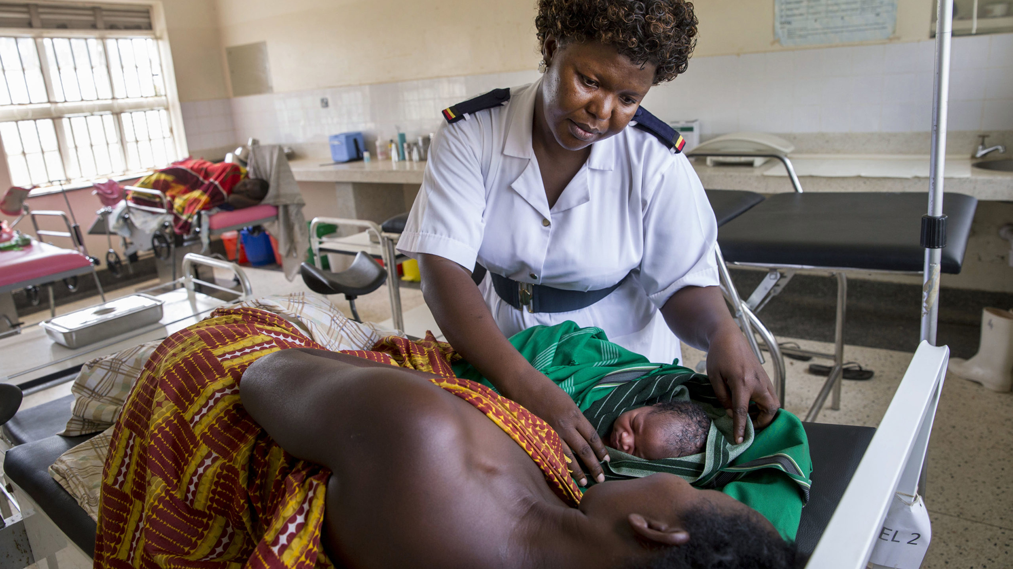 a nurse cares for a mother and child in a clinic