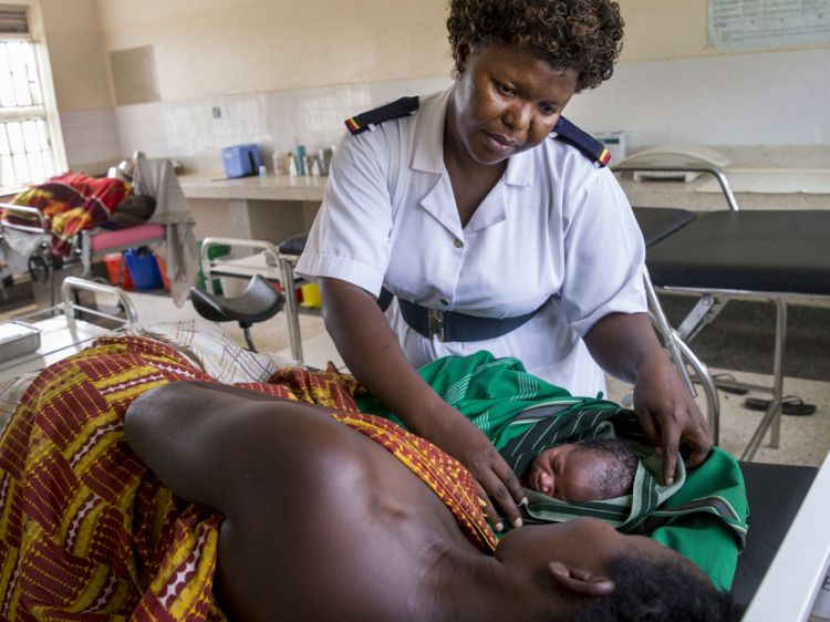 a nurse cares for a mother and child in a clinic